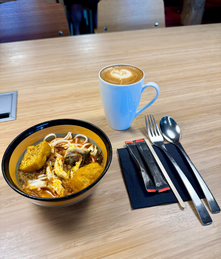 curry noodle with a cup of hot latte at citizenM for breakfast